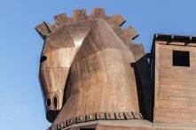 Wooden horse in front of a blue sky